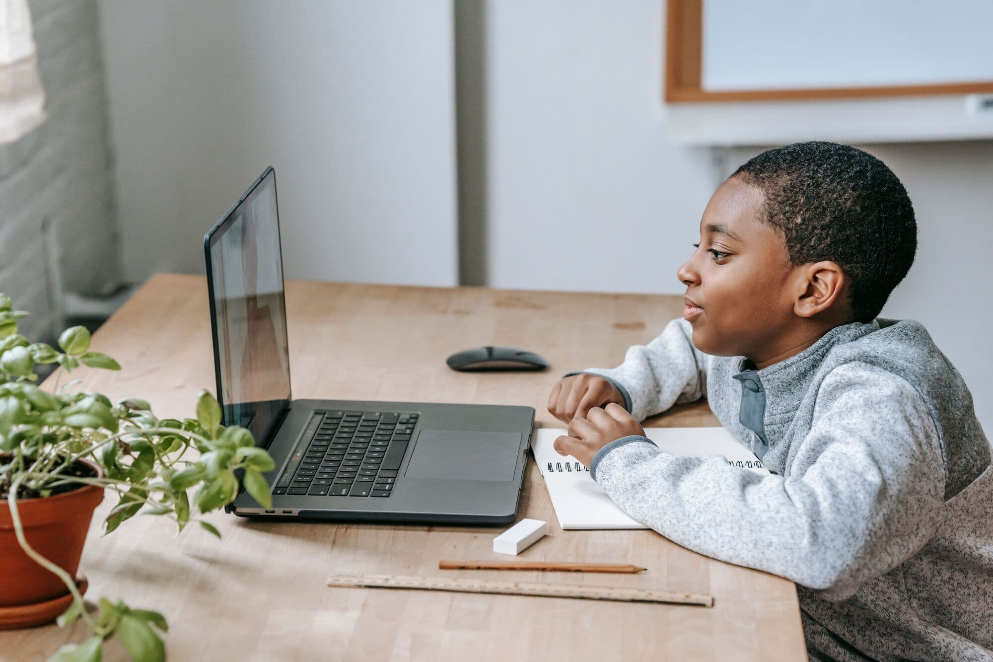 A boy focused on a live online lesson